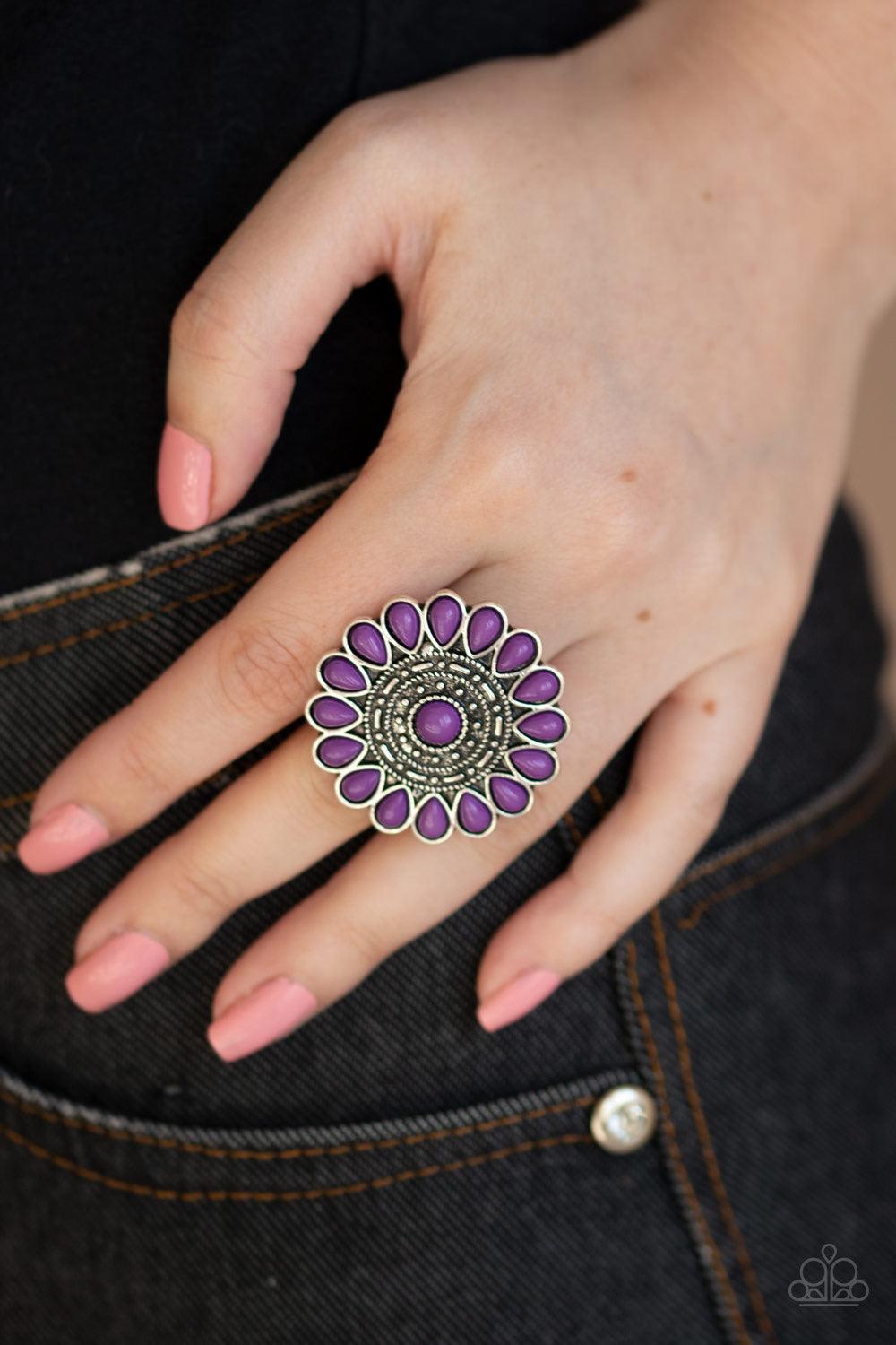 Paparazzi Accessories Posy Paradise - Purple A collection of vivacious purple beaded petals flare out from a textured silver center, creating a whimsical flower atop the finger. Features a stretchy band for a flexible fit. Sold as one individual ring. Jew