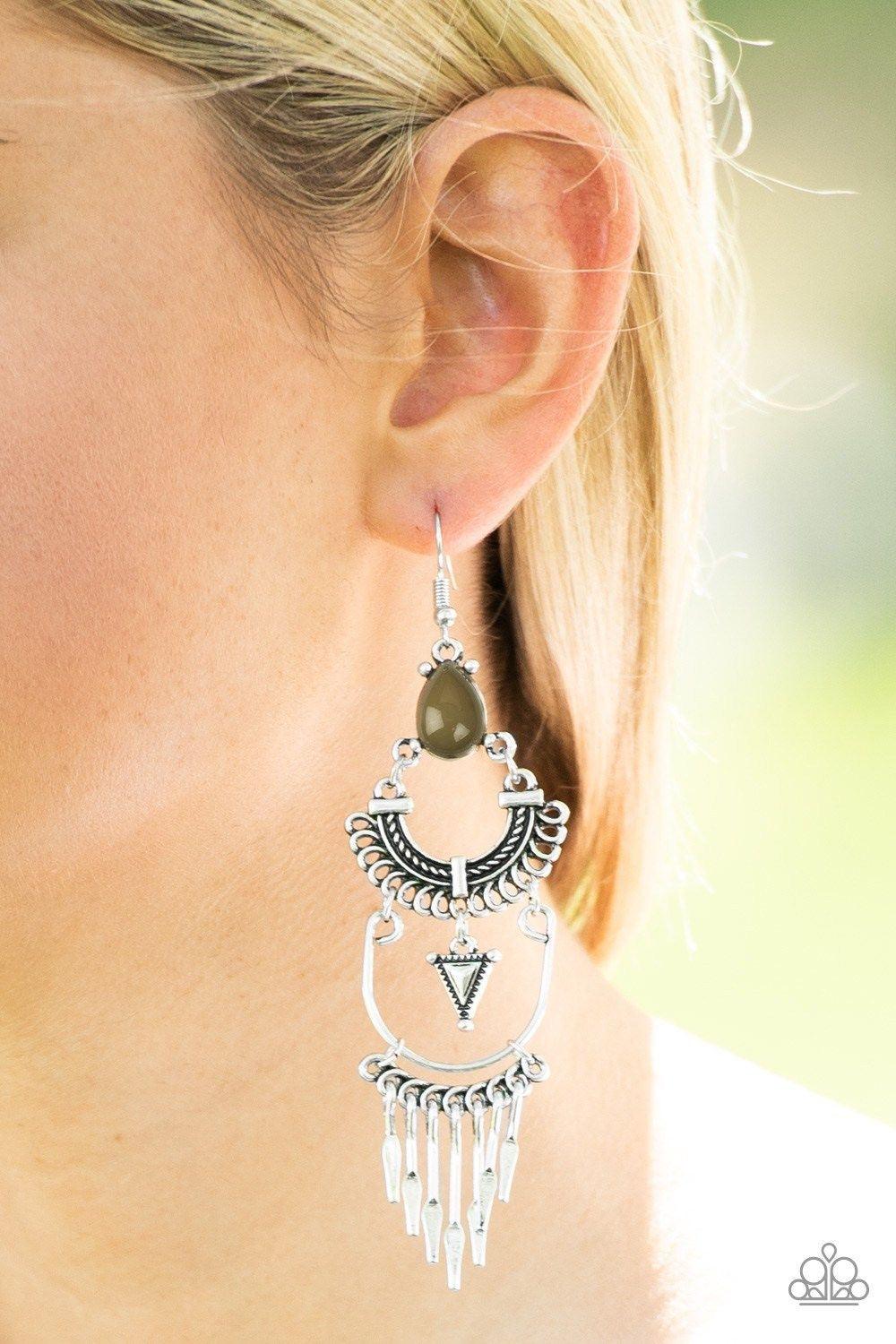 Paparazzi Accessories Progressively Pioneer - Green A Martini Olive teardrop bead sits atop stacked silver frames that are linked together to allow flowy movement. Featuring tribal inspired patterns, the dramatically stacked frames give way to flared rods