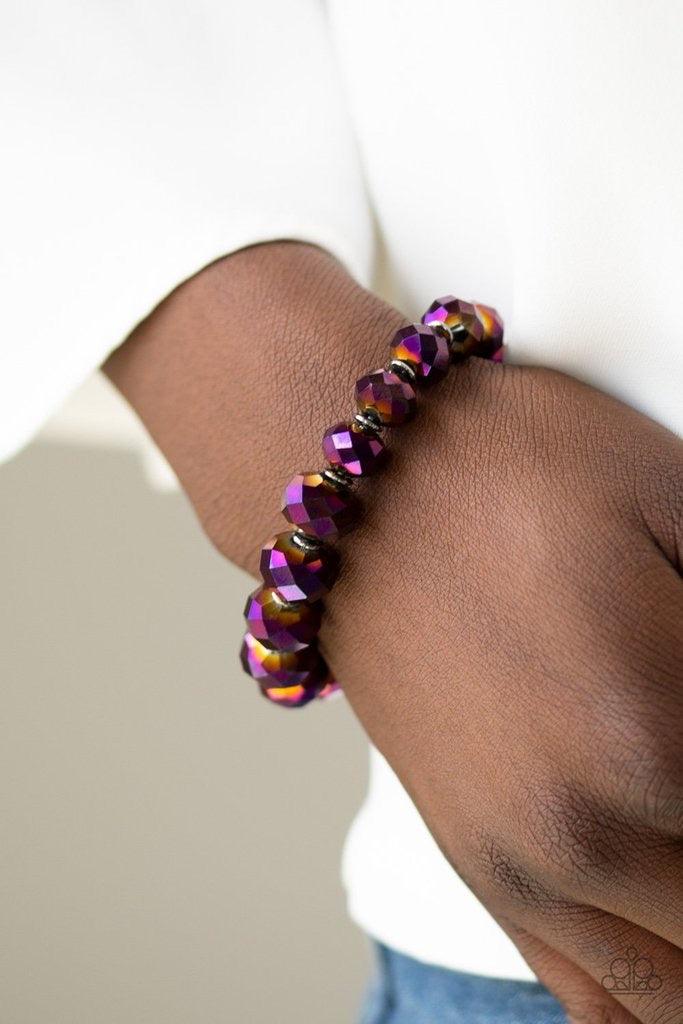 Paparazzi Accessories Beautifully Bewitching - Purple Brushed in an iridescent shimmer, metallic purple gems are threaded along a stretchy band, gradually increasing in size near the center for a dramatic finish. Sold as one individual bracelet. Jewelry