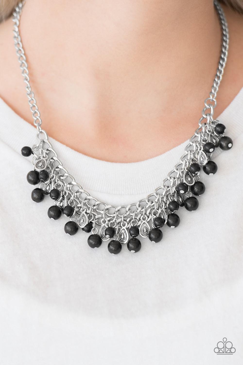 Paparazzi Accessories Poshly Paleo - Black Earthy black stone beading cascades from the bottom of interlocking silver chains, creating an earthy fringe below the collar. Brushed in an antiqued shimmer, textured silver teardrops drip between the colorful b