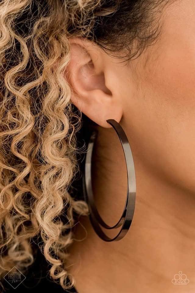 Paparazzi Accessories Moon Child Metro- - Black Two flat gunmetal bars curl into a dizzying hoop for a dramatically edgy look. Earring attaches to a standard post fitting. Hoop measures 2 3/4" in diameter. Jewelry