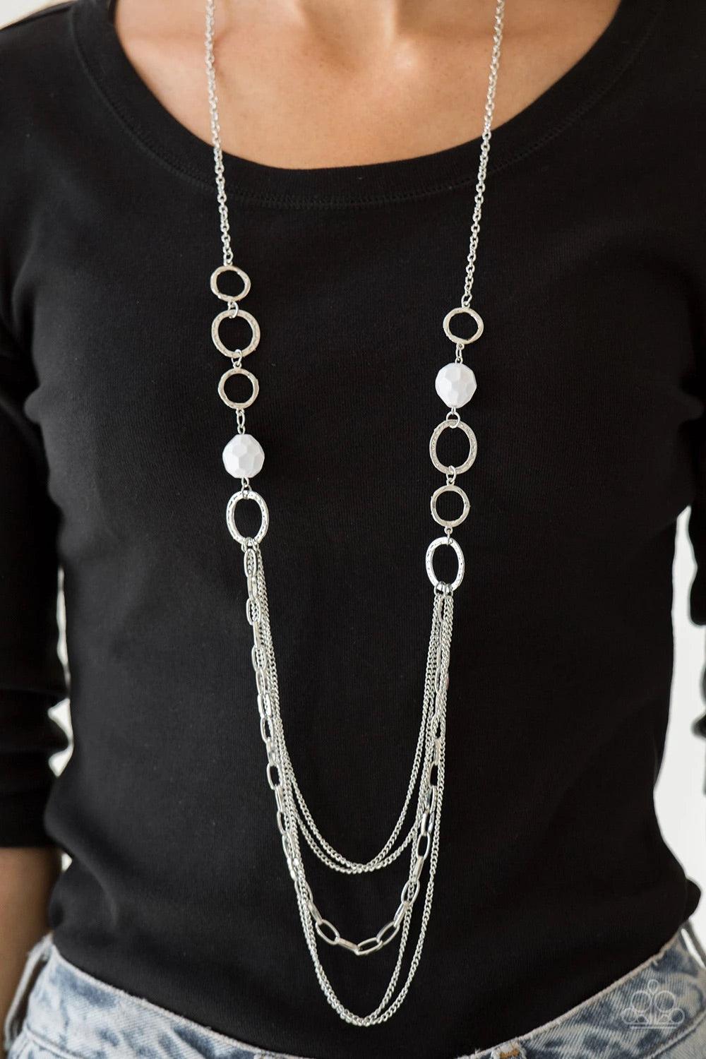 Paparazzi Accessories Margarita Masquerades - White Faceted white beads and hammered silver hoops give way to layers of mismatched silver chains for a whimsical look. Features an adjustable clasp closure. Sold as one individual necklace. Includes one pair