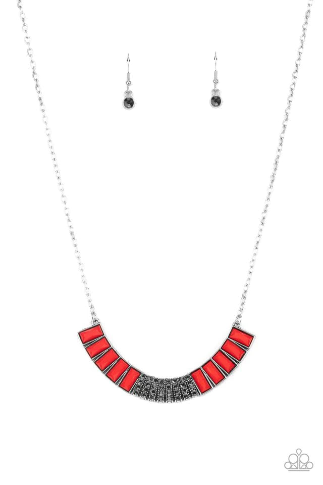 Paparazzi Accessories Coup de MANE - Red Stacked rows of hematite rhinestones and faceted emerald cut Fire Whirl beads coalesce into a colorful half moon pendant, creating a flamboyant pop of color below the collar. Features an adjustable clasp closure. S