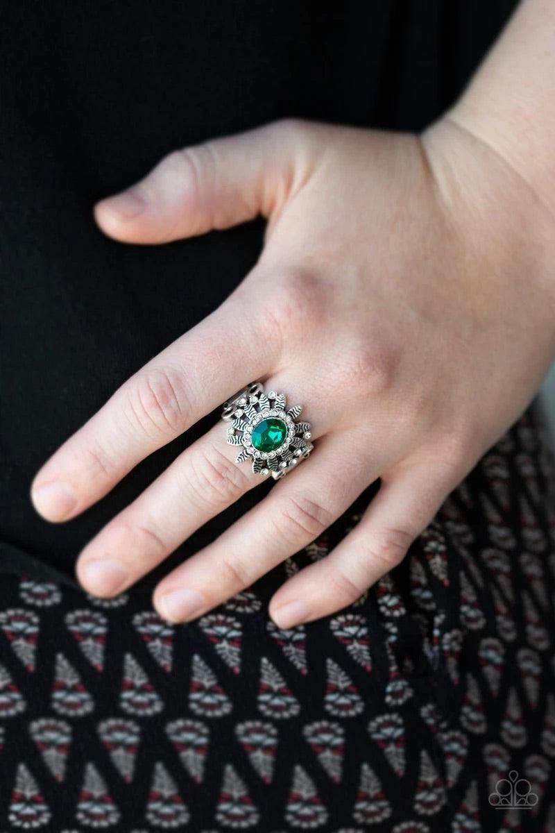 Paparazzi Accessories Burn Bright - Green Ringed in glittery white rhinestones, a sparkling green gem is pressed into the center of a leafy silver frame. Dainty white rhinestones are sprinkled along the shimmery foliage for a refined finish. Features a st