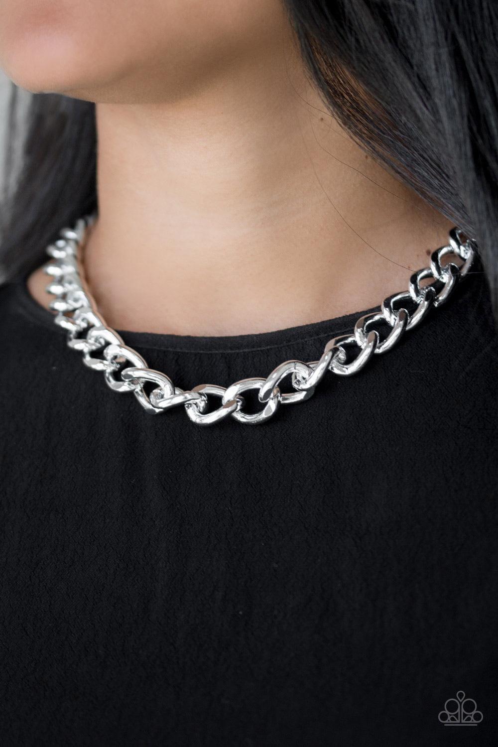 Paparazzi Accessories Heavyweight Champion - Silver Brushed in a high-sheen shimmer, a bold silver chain drapes below the collar in an edgy industrial fashion. Features an adjustable clasp closure. Sold as one individual necklace. Includes one pair of mat