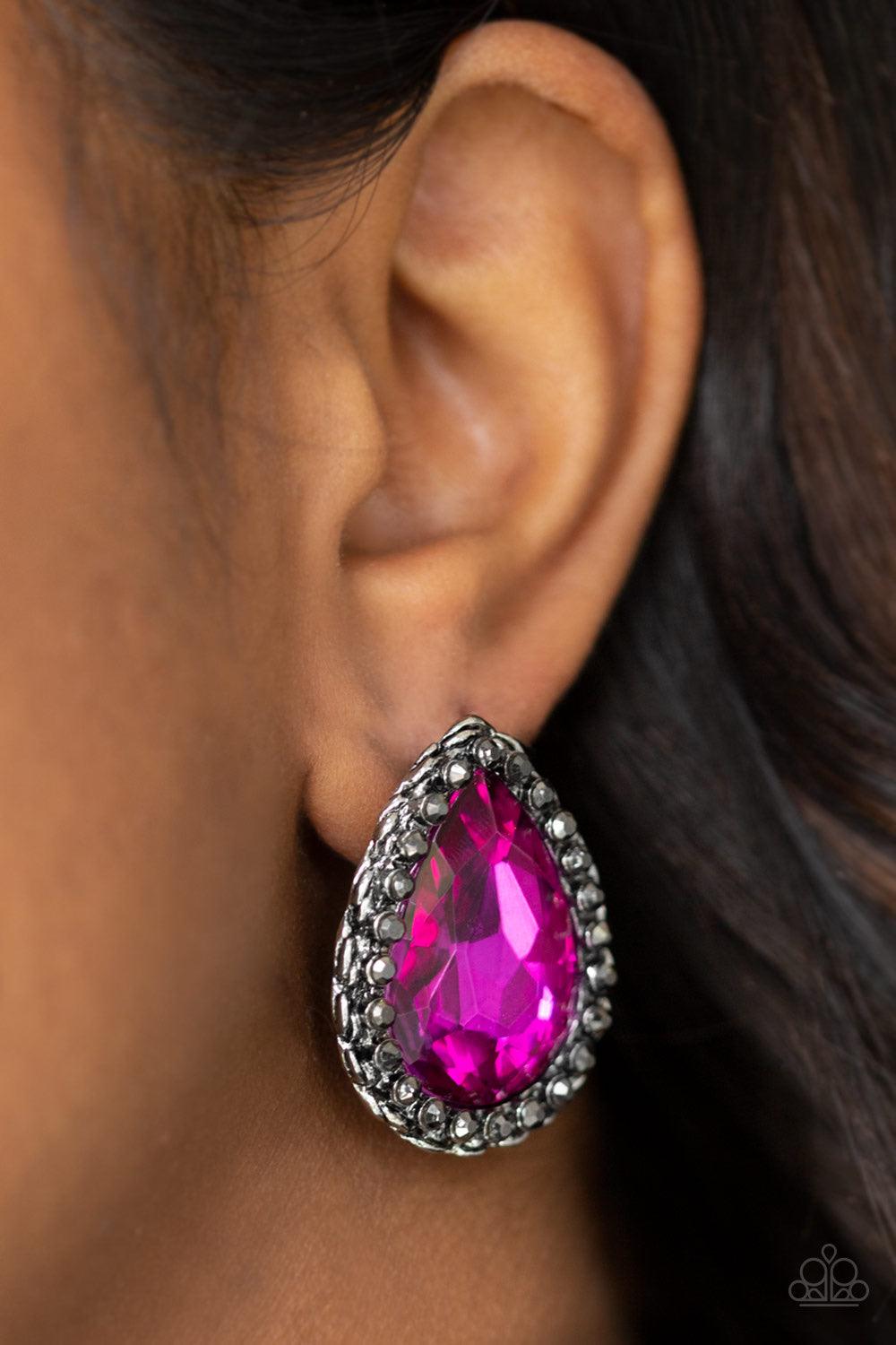 Paparazzi Accessories Dare To Shine - Pink Encrusted in a ring of glittery hematite rhinestones, an overly dramatic pink teardrop gem is pressed into a textured silver frame for a grunge-glamorous look. Earring attaches to a standard post fitting. Jewelry
