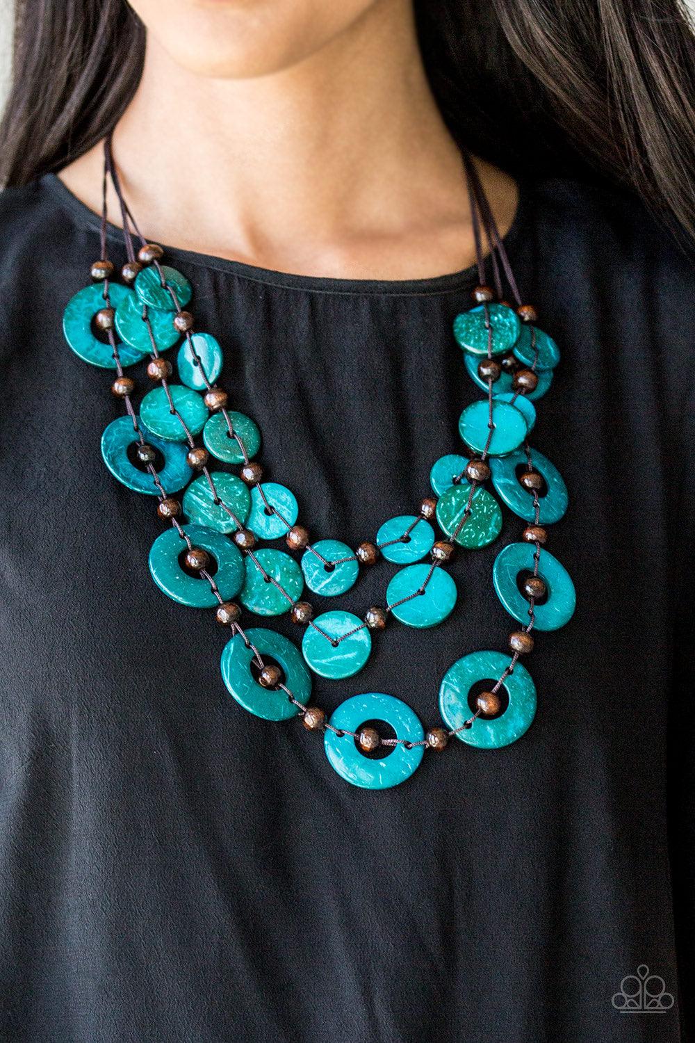 Paparazzi Accessories Catalina Coastin - Blue Brushed in a shell-like iridescence, refreshing blue wooden discs and round brown wooden beads are knotted along three strands of brown cording for a summery look. Features a button loop closure. Jewelry