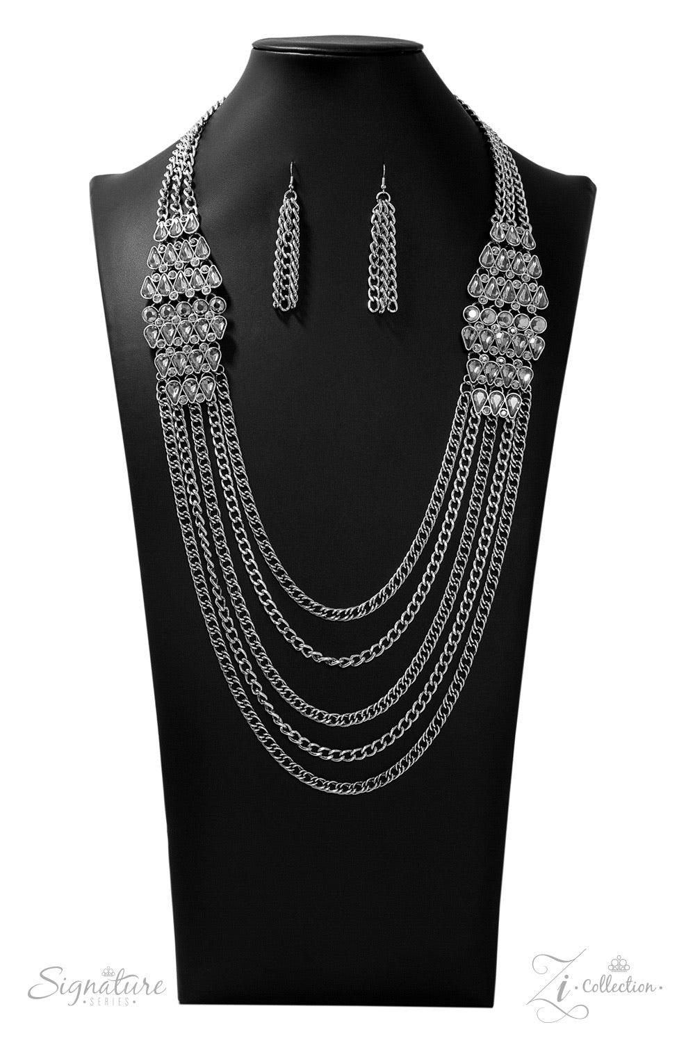 Paparazzi Accessories The Erika 💗ZiCollection $25💗 Haphazardly dotted with dainty hematite rhinestones, row after row of smoky teardrop gems link into stacked ornamental frames that sit boldly on each side of the chest. The mesmerizing duo gives way to