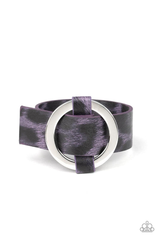 Paparazzi Accessories Jungle Cat Couture - Purple Featuring a shiny purple cheetah pattern, a textured piece of leather loops through the center of a shimmery silver hoop for a sassy urban look. Features an adjustable belt loop closure. Sold as one indivi