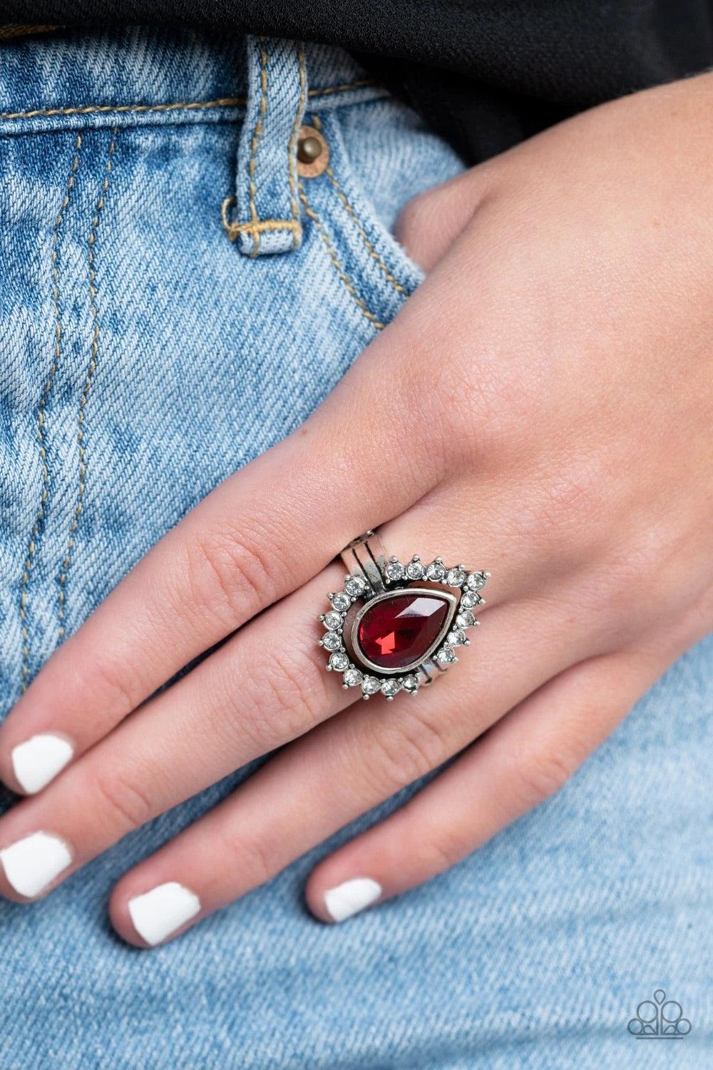 Paparazzi Accessories Make Your Trademark - Red A ring of glittery white rhinestones fans out from a dramatically oversized red teardrop rhinestone center, creating the illusion of a floating centerpiece. Features a stretchy band for a flexible fit. Jewel