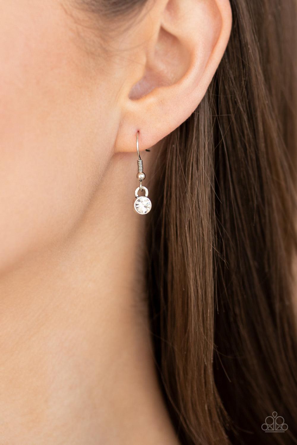 Paparazzi Accessories Lovely Luminosity - Silver *Lanyard Attached to a white rhinestone encrusted fitting, an oversized heart cut gem pendant swings from the bottom of a shimmery silver chain for a charming look. A lobster clasp hangs from the bottom of