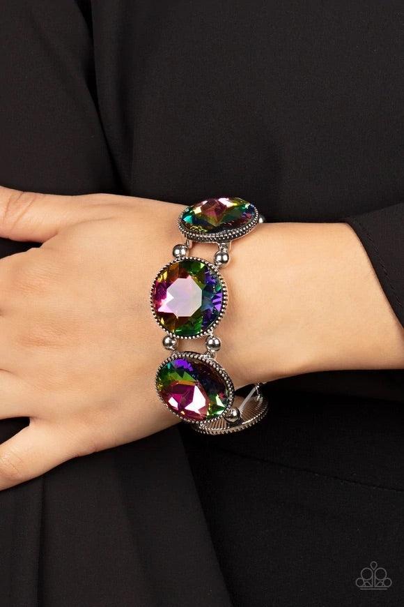Paparazzi Accessories Powerhouse Hustle - Multi Infused with pairs of silver beads, a glitzy collection of dramatically oversized oil spill rhinestone frames are threaded along stretchy bands around the wrist for a jaw-dropping dazzle. Sold as one individ