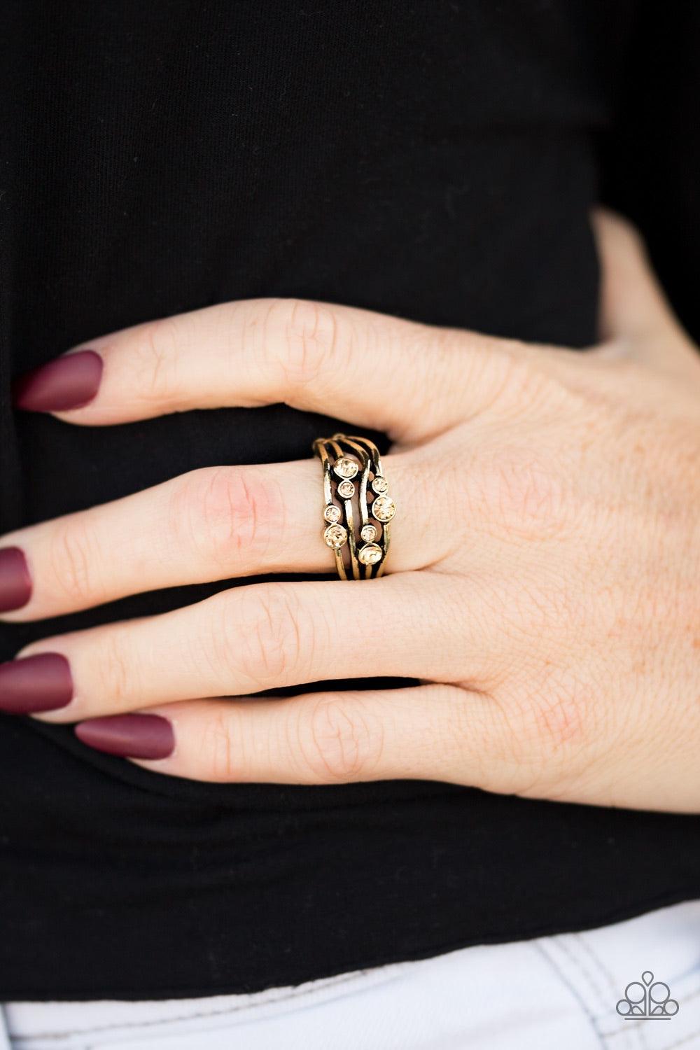 Paparazzi Accessories Welcome to GLEAMland - Brass Glittery topaz rhinestones are sprinkled across wavy brass bars, creating a refined band. Features a dainty stretchy band for a flexible fit. Jewelry