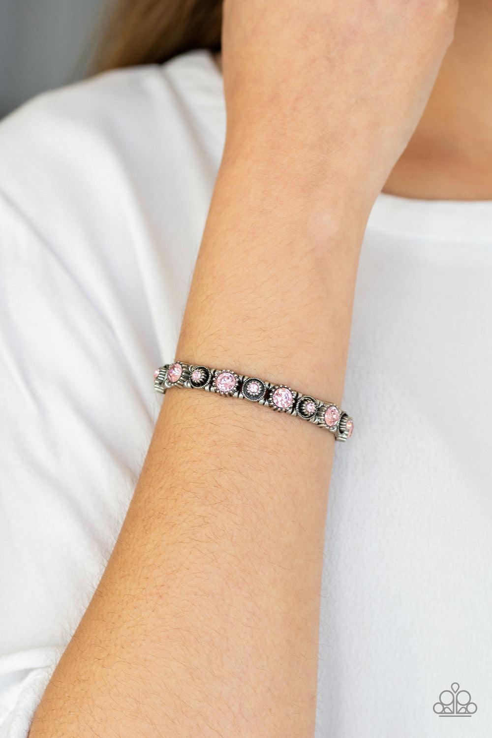 Paparazzi Accessories Heavy On The Sparkle - Pink Featuring glassy pink rhinestone centers, a collection of square silver frames slide along stretchy bands around the wrist for a glamorous look. Jewelry