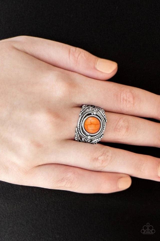 Paparazzi Accessories Stand Your Ground - Orange A refreshing orange stone is pressed into an ornate silver band radiating with rope-like and studded textures for a seasonal look. Features a stretchy band for a flexible fit. Sold as one individual ring. J