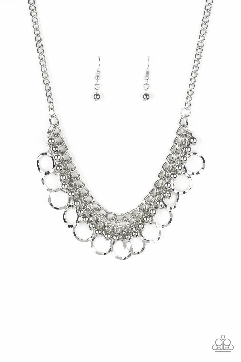 Paparazzi Accessories Ring Leader Radiance - Silver Rows of shiny silver beads and hammered rings swing from the bottom of interlocking silver chains, creating a bold fringe below the collar. Features an adjustable clasp closure. Sold as one individual ne