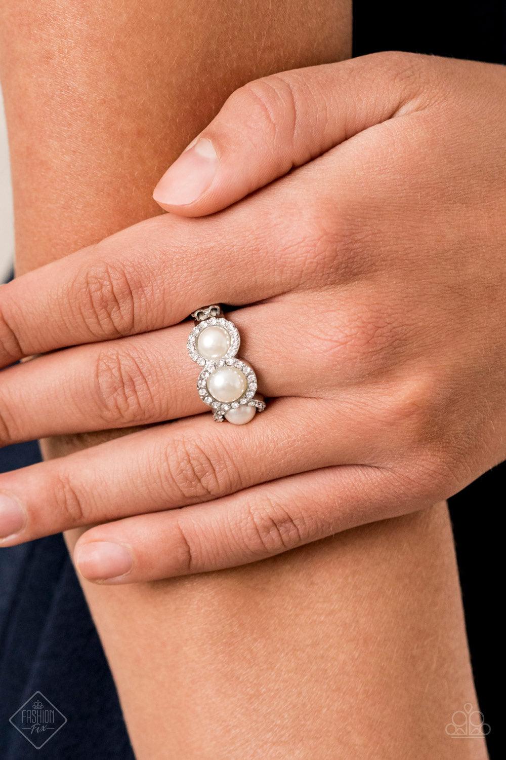 Paparazzi Accessories Shut The Front DIOR! - White Encrusted in rings of glassy white rhinestones, three dainty white pearls delicately adorn the front of a silver band for a timeless look. Features a dainty stretchy band for a flexible fit. Jewelry