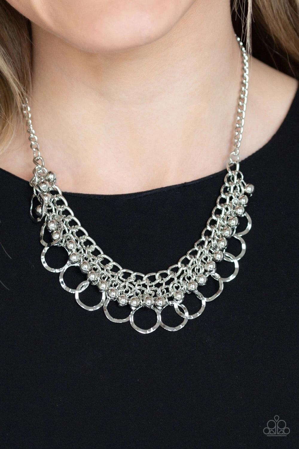 Paparazzi Accessories Ring Leader Radiance - Silver Rows of shiny silver beads and hammered rings swing from the bottom of interlocking silver chains, creating a bold fringe below the collar. Features an adjustable clasp closure. Sold as one individual ne