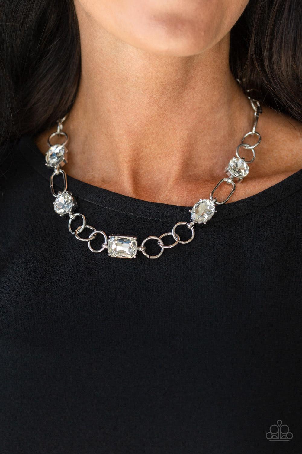 Paparazzi Accessories Urban District - White Featuring round, oval, and emerald style cuts, glittery white rhinestone fittings link with mismatched silver rings below the collar for an edgy glamorous look. Features an adjustable clasp closure. Sold as one