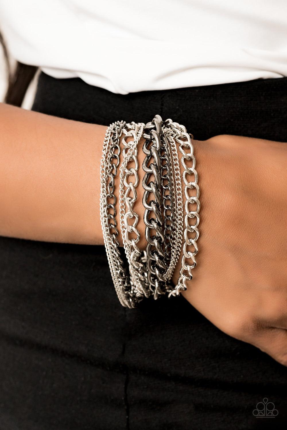 Paparazzi Accessories Metallic Horizon - Multi A gritty mix of mismatched silver and gunmetal chains is strung between two hammered silver fittings, creating edgy layers around the wrist. Features an adjustable clasp closure. Jewelry