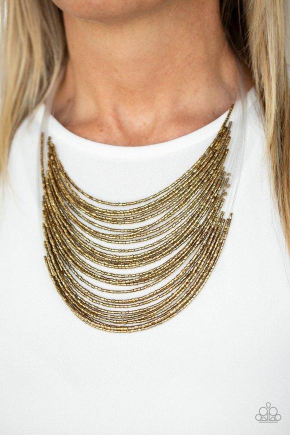 Paparazzi Accessories Catwalk Queen - Brass Strand after strand of shimmering brass seed beads fall together to create a bold statement piece. Features an adjustable clasp closure. Sold as one individual necklace. Includes one pair of matching earrings. J