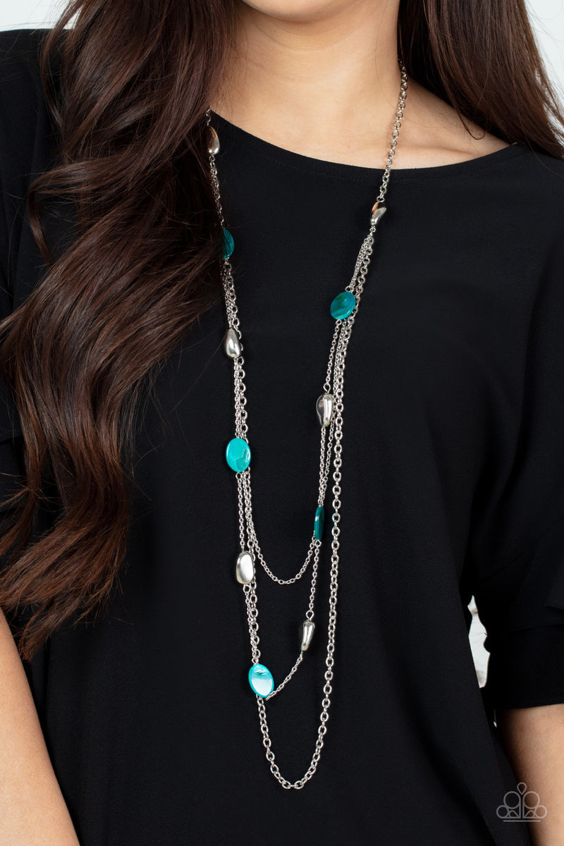 Paparazzi Accessories Barefoot And Beachbound - Blue A strand of silver pebble beads and blue shell-like discs layer with two mismatched silver chains across the chest, adding a seasonal pop of color to any outfit. Features an adjustable clasp closure. So