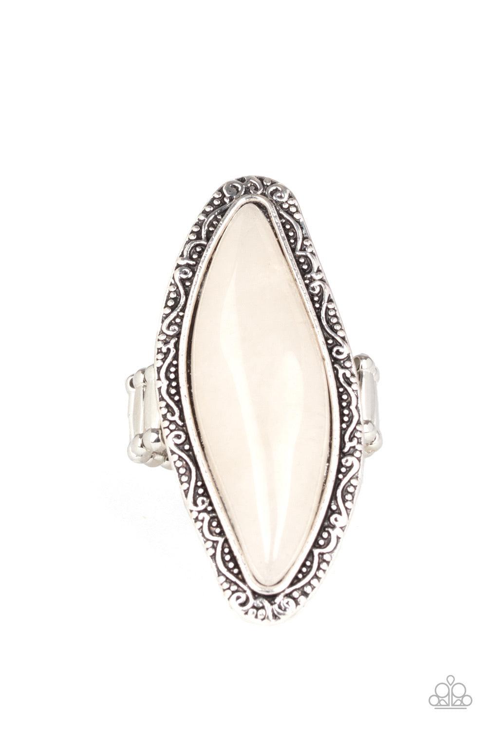 Paparazzi Accessories Mineral Mine - White An oblong white stone is pressed into a shimmery silver frame embossed and studded in tactile filigree, creating a dramatic stone display atop the finger. Features a stretchy band for a flexible Jewelry