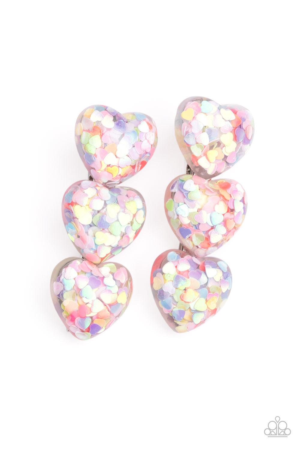 Paparazzi Accessories Heart Full of Confetti - Multi Filled with iridescent multicolored heart-shaped sequins, trios of bubbly heart-shaped acrylic frames coalesce into a flirtatious pair of hair clips. Features a standard hair clip on the back. Hair Acce