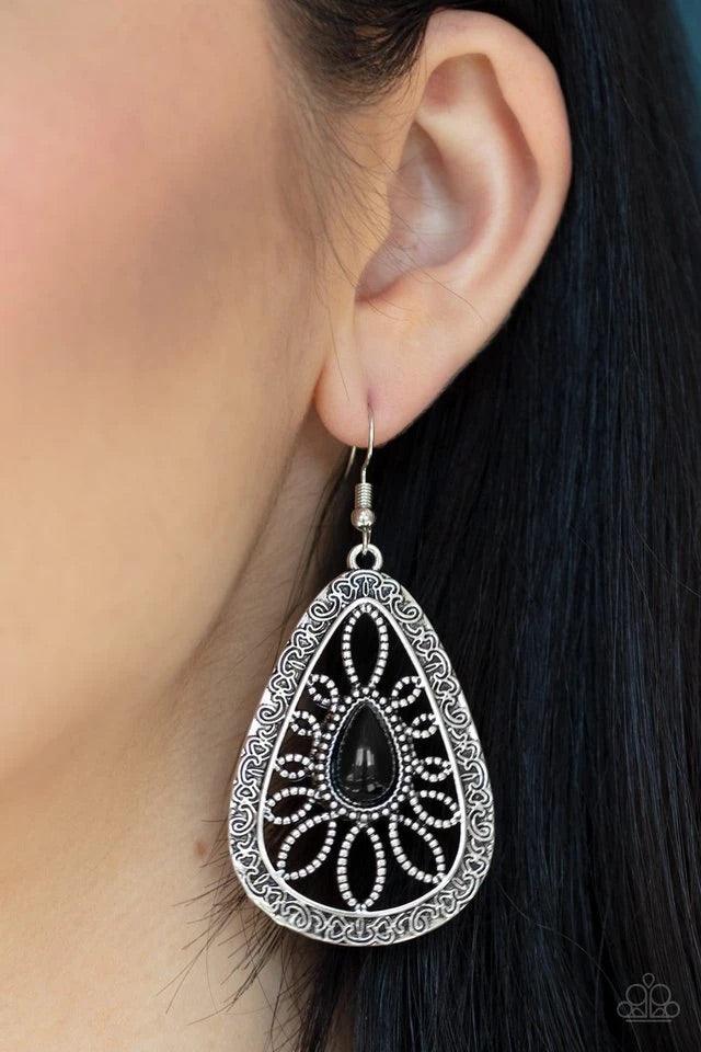 Paparazzi Accessories Floral Frill - Black A shiny black bead is pressed into the center of an ornate silver teardrop frame studded and embossed in swirling filigree detail for a whimsical look. Earring attaches to a standard fishhook fitting. Sold as one
