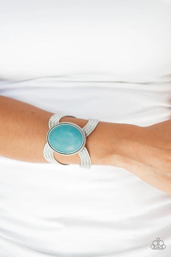 Paparazzi Accessories Coyote Couture - Blue A dramatic turquoise stone pendant is pressed into the center of textured silver bars, creating a bold seasonal cuff. Sold as one individual bracelet. Jewelry