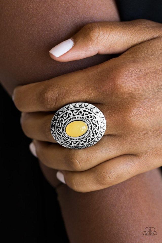 Paparazzi Accessories Hello, Sunshine - Yellow A glowing yellow stone is pressed in the center of a dramatic silver frame radiating with shimmery sunburst details for a seasonal look. Features a stretchy band for a flexible fit. Sold as one individual rin