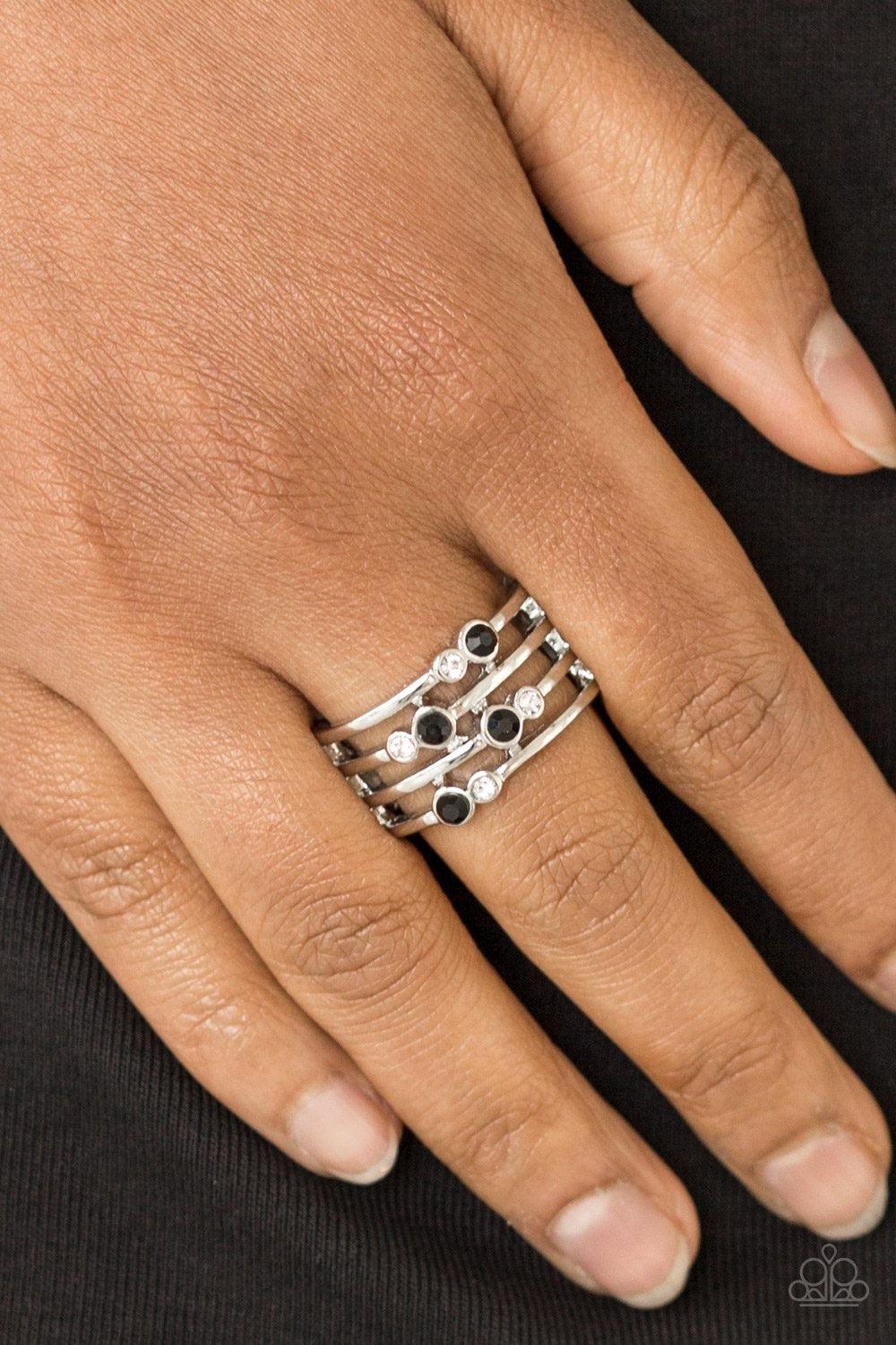 Paparazzi Accessories Sparkle Showdown - Black Glittery black and white rhinestones are scattered along arcing silver bands, coalescing into a refined frame. Features a stretchy band for a flexible fit. Sold as one individual ring. Jewelry