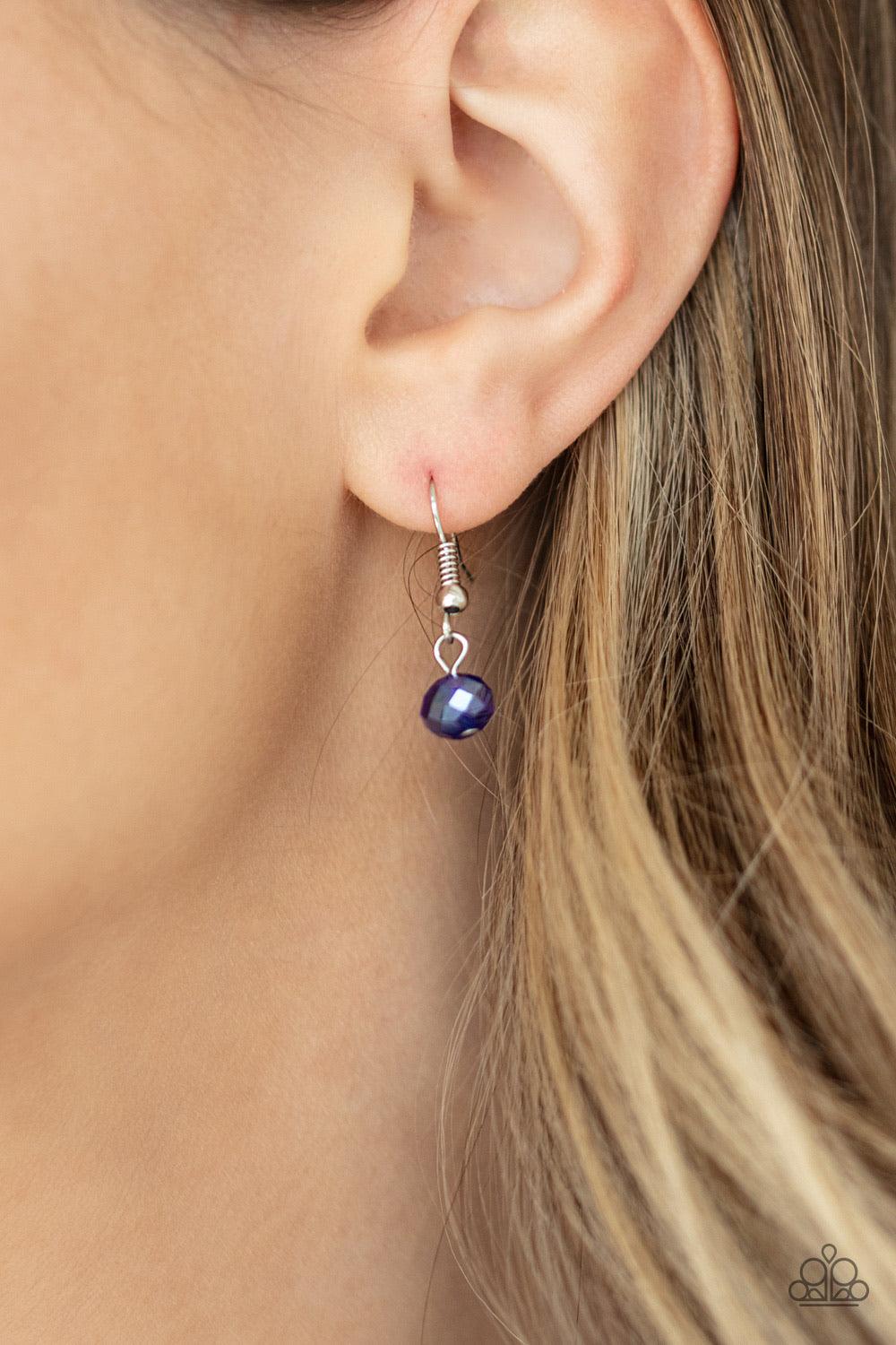 Paparazzi Accessories Iridescent Illumination - Blue A fringe of white, opaque, and iridescent blue crystal-like beads dangle from the bottom of a shimmery silver chain. Matching round and teardrop beads cascade from an extended silver chain at the center
