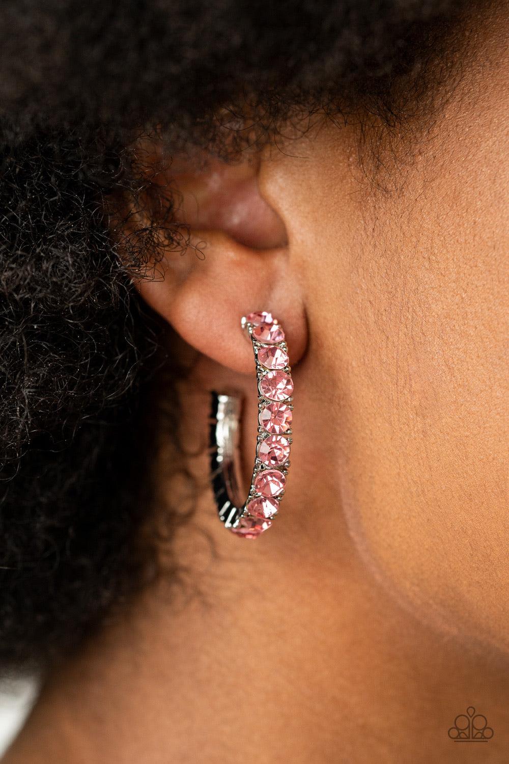 Paparazzi Accessories CLASSY is in Session - Pink An oversized collection of glittery pink rhinestones are encrusted along a textured silver hoop, creating a glamorous sparkle. Earring attaches to a standard post fitting. Hoop measures approximately 1 1/2