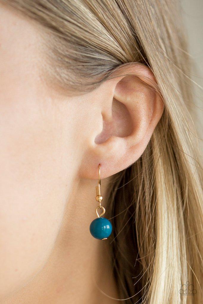Paparazzi Accessories Tour De Trendsetter - Blue Varying in shape, glassy and polished blue beads swing from the bottom of interlocking gold chains. Crystal-like teardrops are sprinkled along the colorful beading, creating a flirtatious fringe below the c
