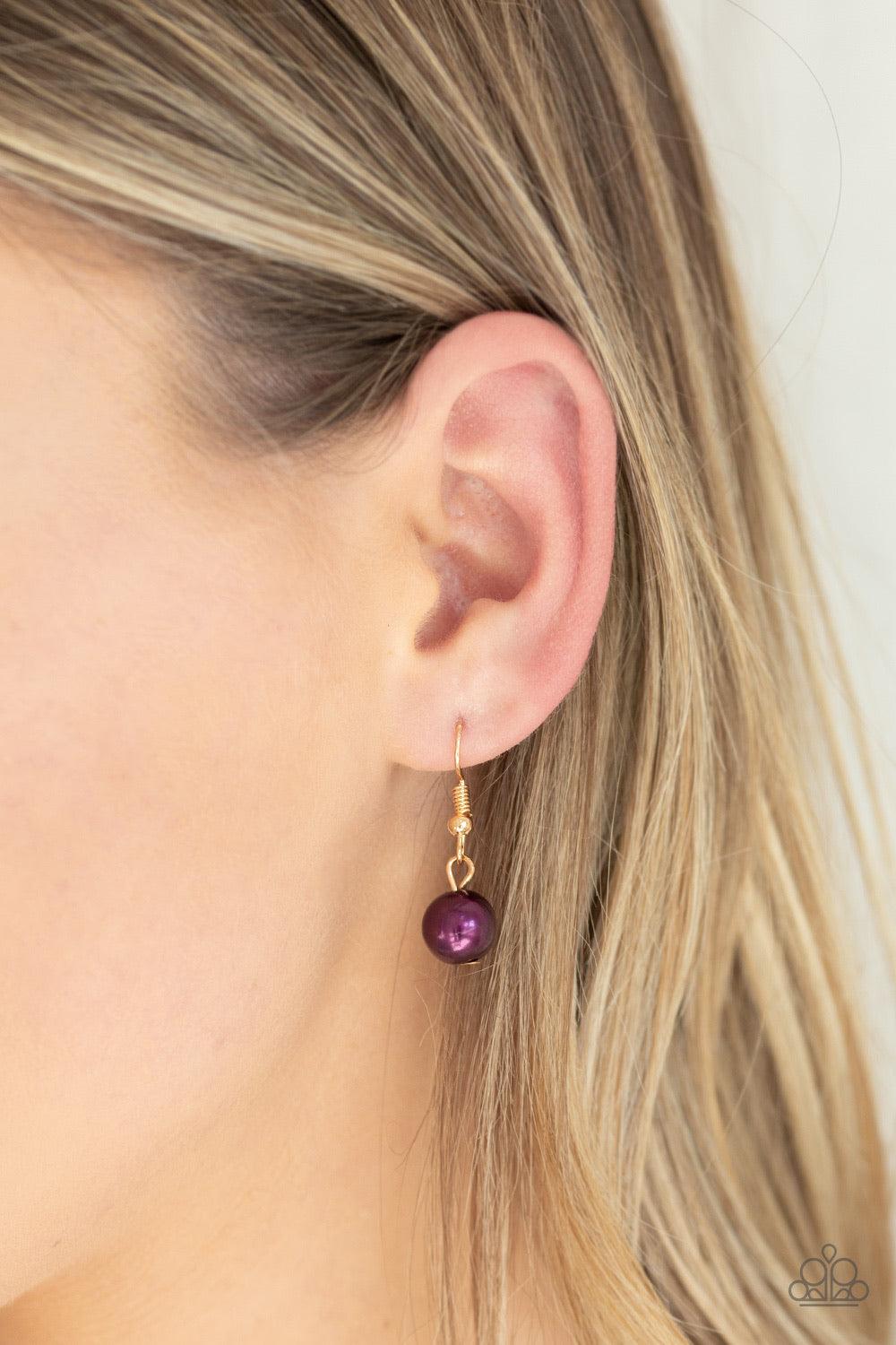Paparazzi Accessories Belle of the BALLROOM - Purple A dramatic pearly purple bead swings from the bottom of an elegantly elongated gold chain. Featuring a hammered fitting, a gold tassel streams from the bottom of the colorful pendant for a refined finis