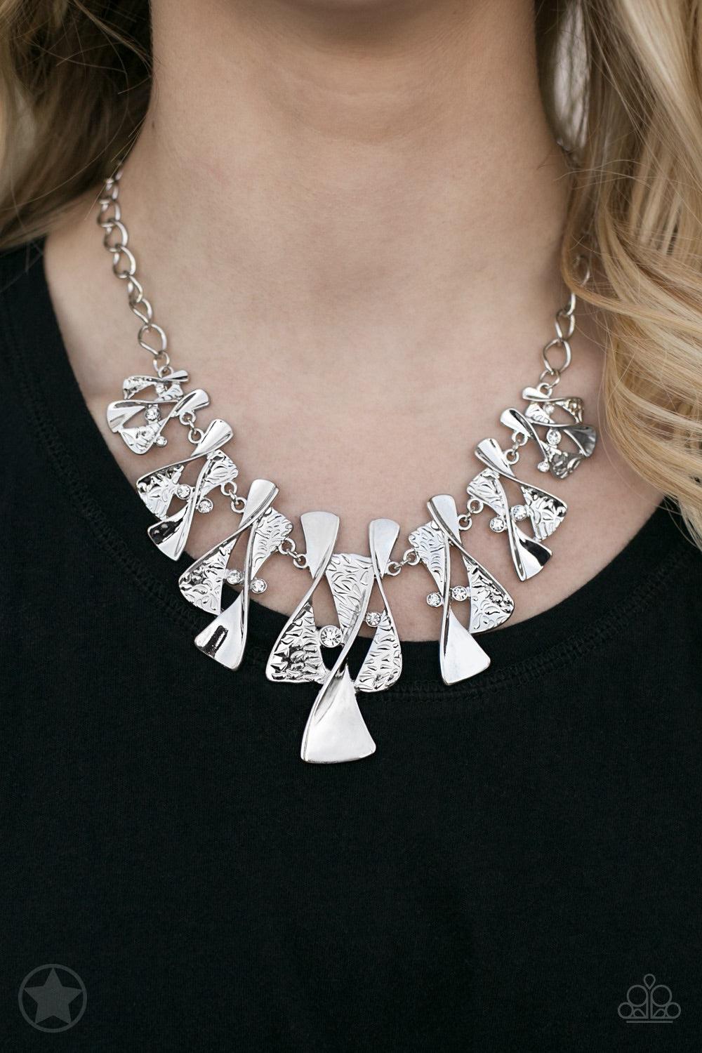 Paparazzi Accessories The Sands Of Time - Silver Twisted silver hourglasses dance along a chunky silver chain with tiny clear rhinestones adding sparkling, elegant accents. Beautiful textured pieces add depth to the design. Features an adjustable clasp cl