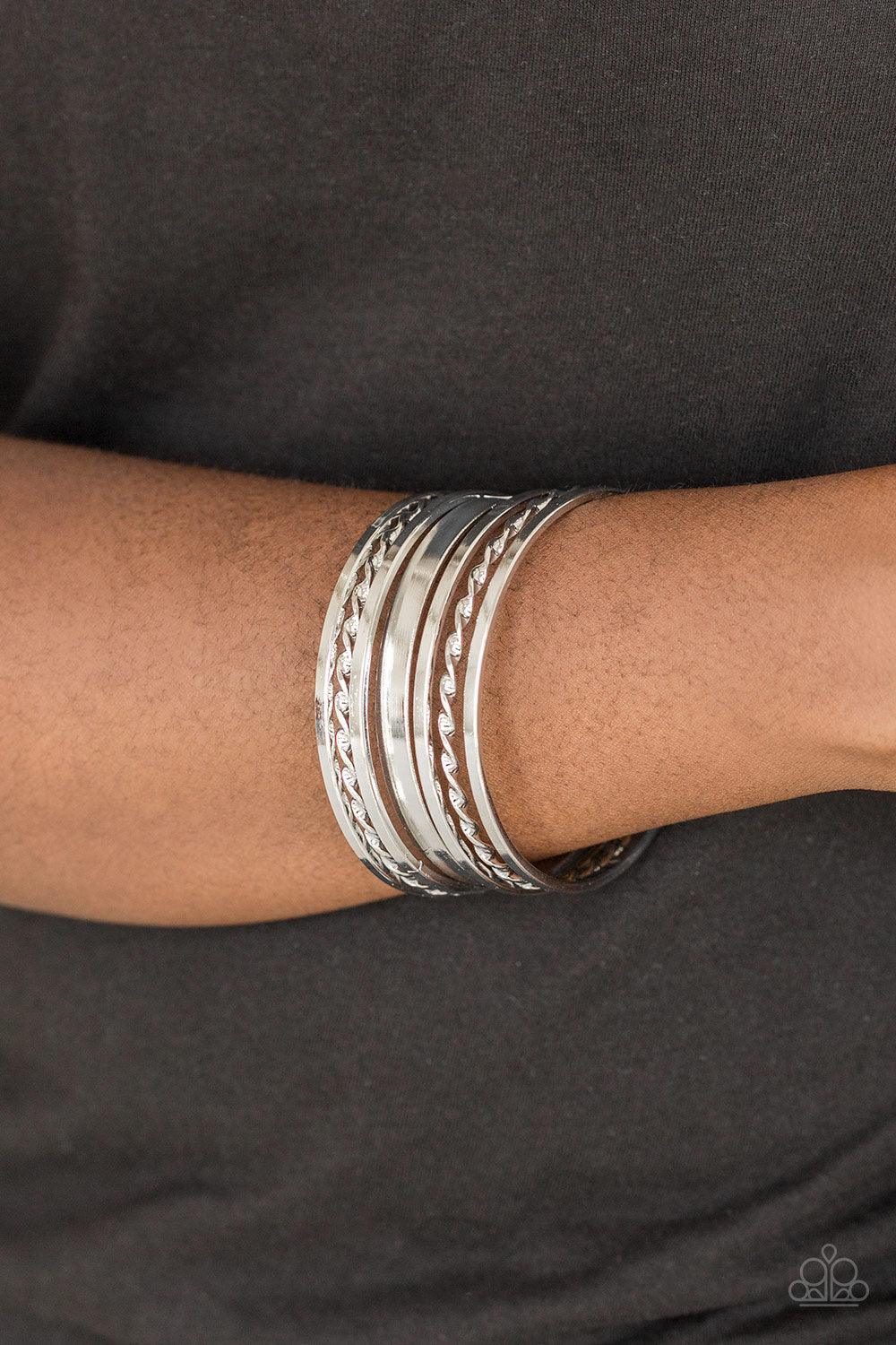 Paparazzi Accessories Basic Blend - Silver Featuring smooth and twisted surfaces, mismatched silver bangles stack across the wrist for a casual look. Jewelry