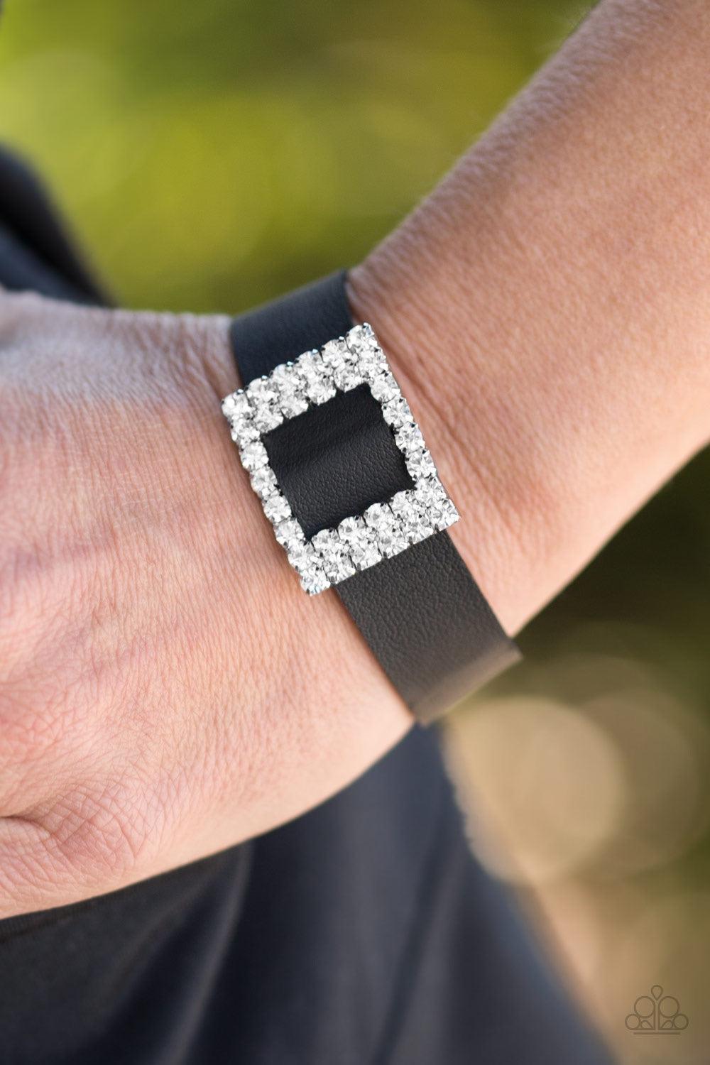 Paparazzi Accessories Diamond Diva ~Black Encrusted in glassy white rhinestones, a dazzling frame slides along a strip of black leather, creating a blinding centerpiece atop the wrist. Features an adjustable snap closure.