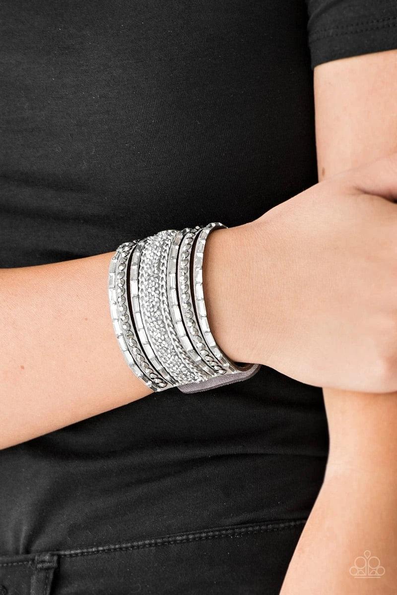 Paparazzi Accessories Rhinestone Rumble - Silver White emerald-cut rhinestones, hematite rhinestones, and metallic prism-shaped rhinestones are sprinkled along strands of gray suede. Shimmery silver chain is added to the mix for a sassy industrial finish.