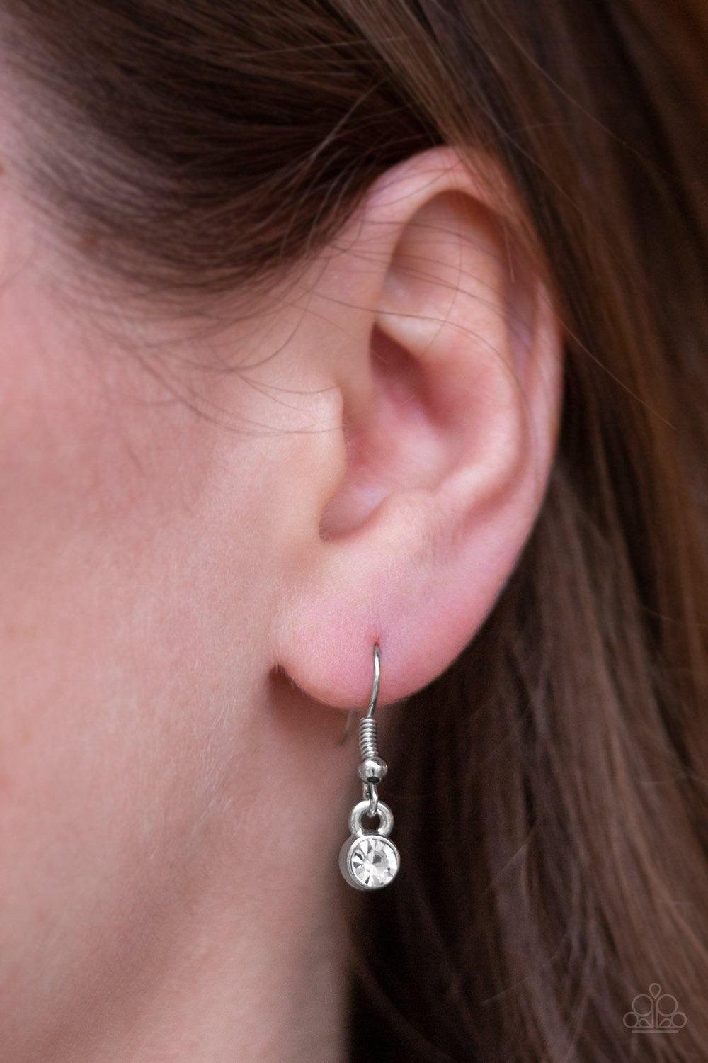 Paparazzi Accessories Five-Star Starlet - White Encased in sleek silver frames, a collection of glittery white rhinestones coalesce into dazzling frames below the collar. Matching rhinestones trickle from the center, creating a glamorous extended pendant.