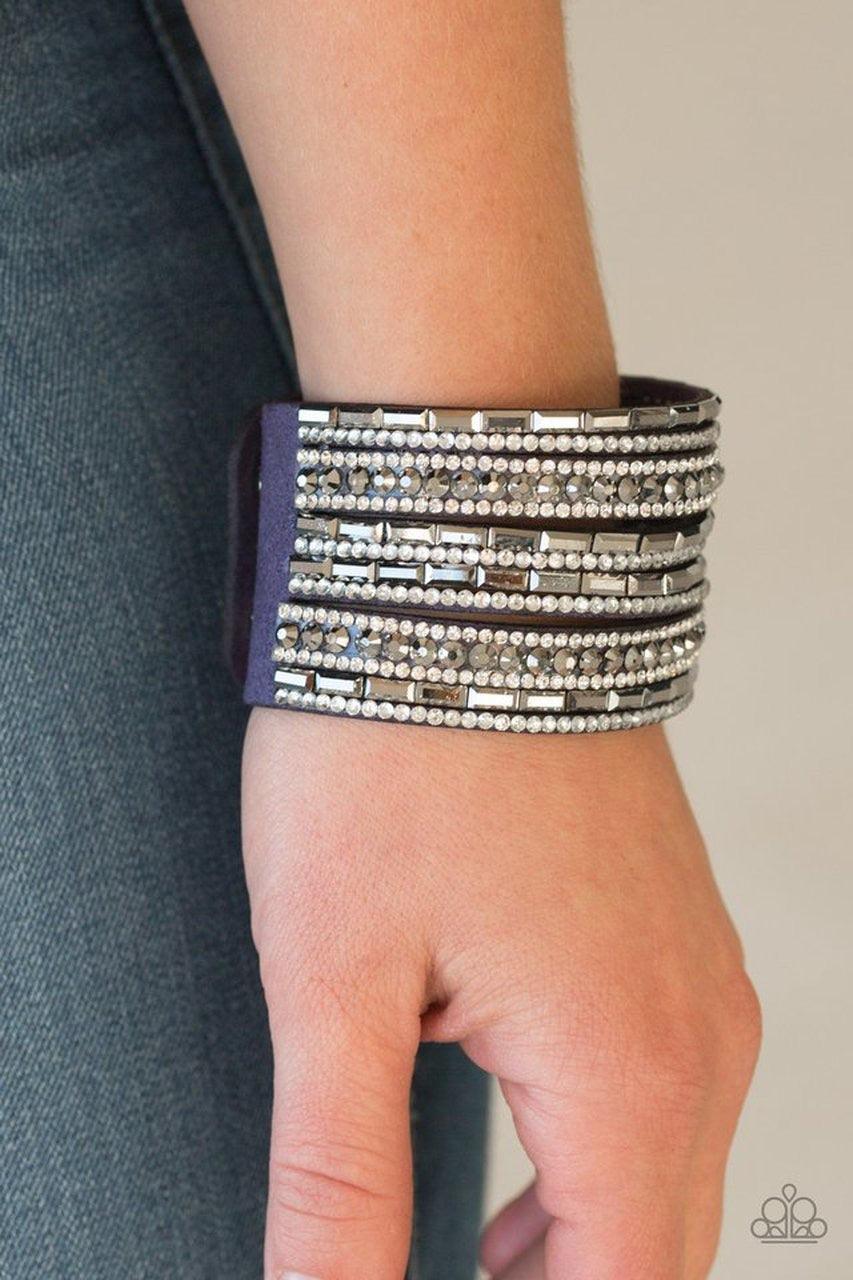 Paparazzi Accessories Wham Bam Glam - Blue Varying in size and shape, glassy white and smoky hematite rhinestones are encrusted along strands of blue suede for a sassy look. Features an adjustable snap closure. Jewelry