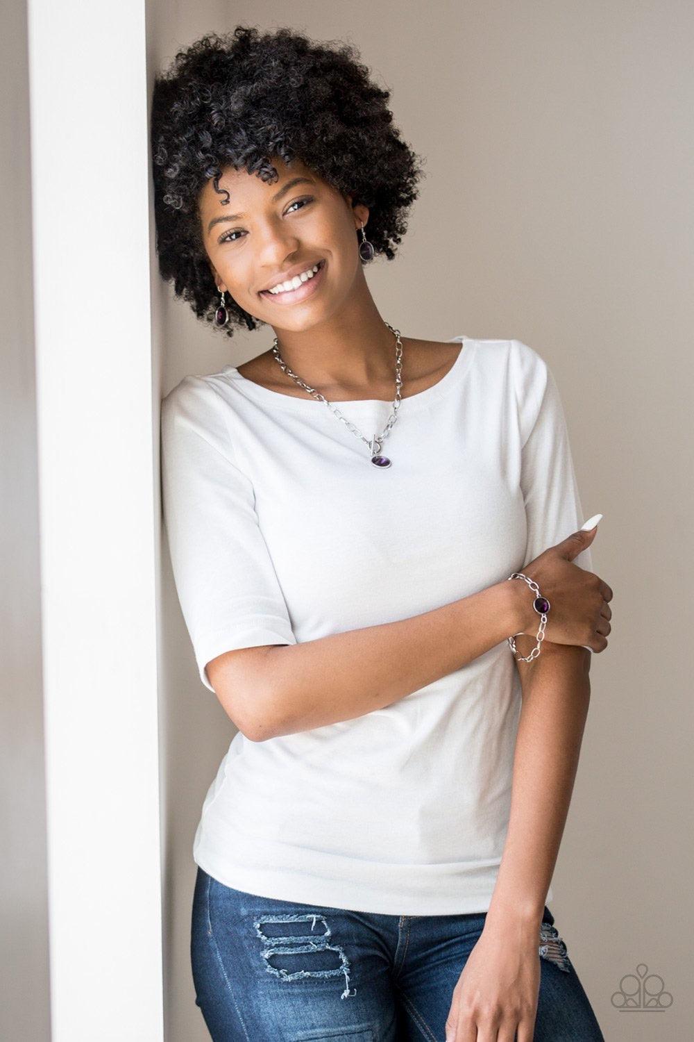 Paparazzi Accessories She Sparkles On - Purple A dramatic purple gem swings from the bottom of a shiny silver chain, creating a blinding pendant below the collar. Features a toggle closure. Jewelry