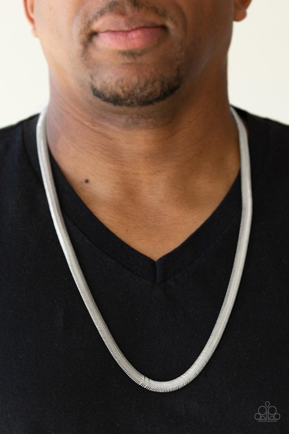 Paparazzi Accessories Kingpin - Silver Featuring a high-sheen finish, a thick silver herringbone chain drapes across the chest for a sleek, upscale look. Features an adjustable clasp closure. Sold as one individual necklace. Jewelry