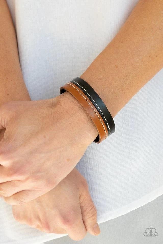 Paparazzi Accessories Simply Safari - Black Strands of tan and black leather are stitched together, creating a rugged display around the wrist. Features an adjustable snap closure. Sold as one individual bracelet. Jewelry