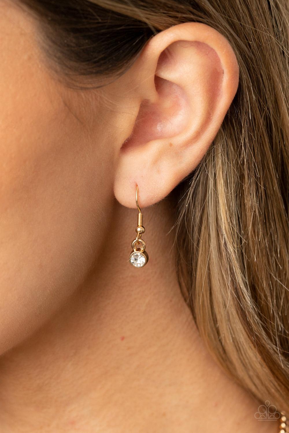 Paparazzi Accessories GLOW-Getter Glamour - Gold Crowned in a trio of dainty white rhinestones, an exaggerated display of oversized white gems delicately link below the collar for a glamorous glow. Features an adjustable clasp closure. Sold as one individ