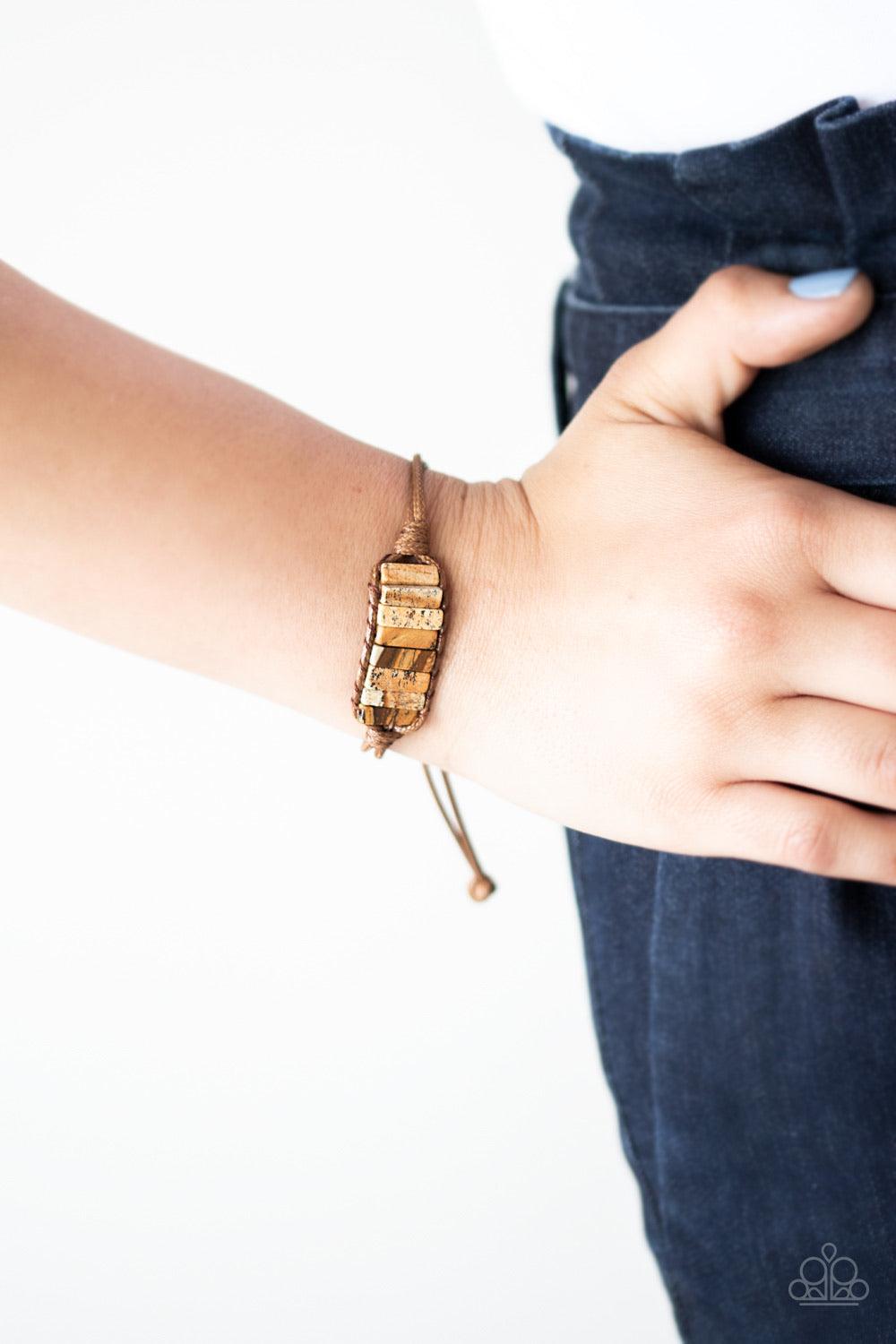 Paparazzi Accessories Canyon Warrior - Brown Chiseled into tranquil rectangular shapes, a colorful row of natural stones are knotted in place around the wrist with a piece of brown cording for an earthy look. As the stone elements in this piece are natura