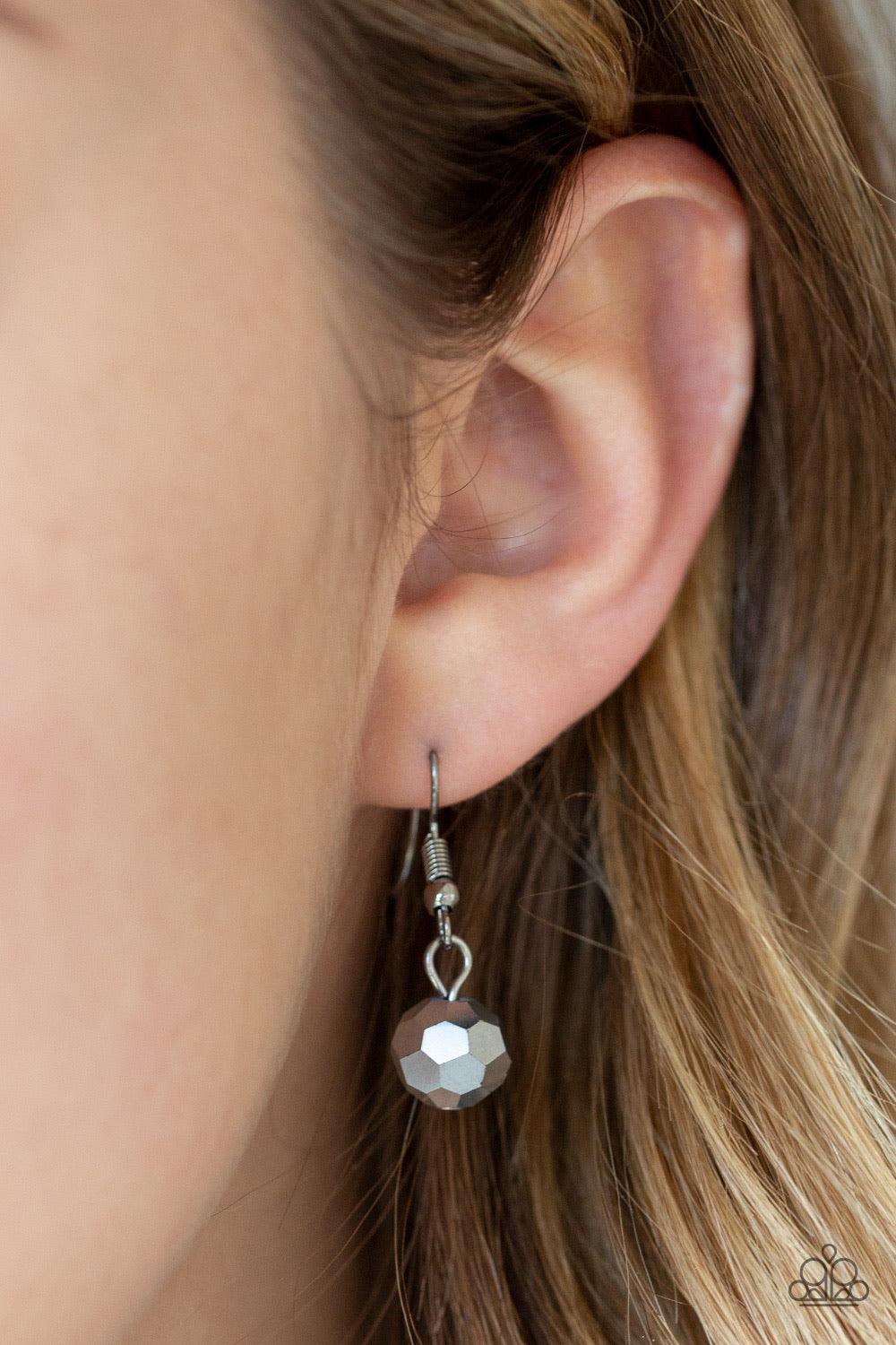 Paparazzi Accessories Never A Dull Moment - Multi A trio of faceted hematite crystal-like beads asymmetrically trickle along a mismatched gunmetal chain. Featuring a regal emerald-cut, an oversized rainbow gem swings from the bottom of the gunmetal chain