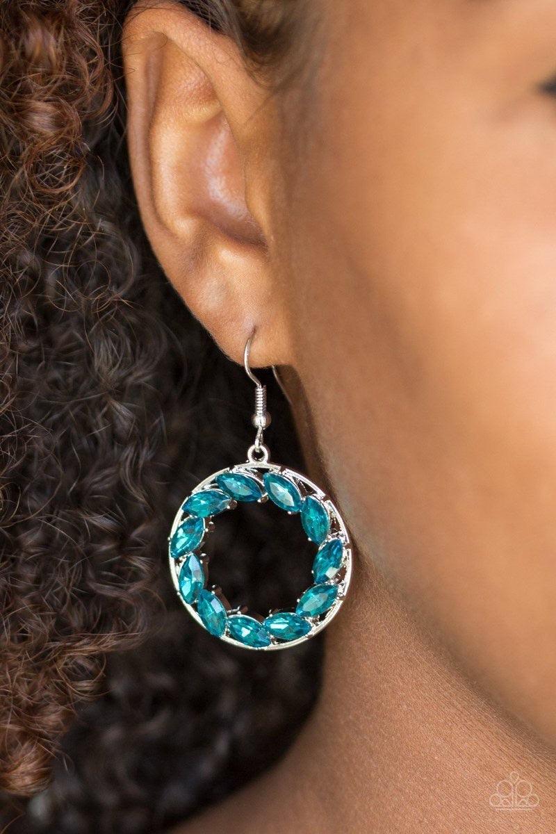 Paparazzi Accessories Global Glow - Blue Featuring regal marquise style cuts, blue rhinestones are encrusted along a shimmery silver hoop for a radiant fashion. Earring attaches to a standard fishhook fitting. Jewelry