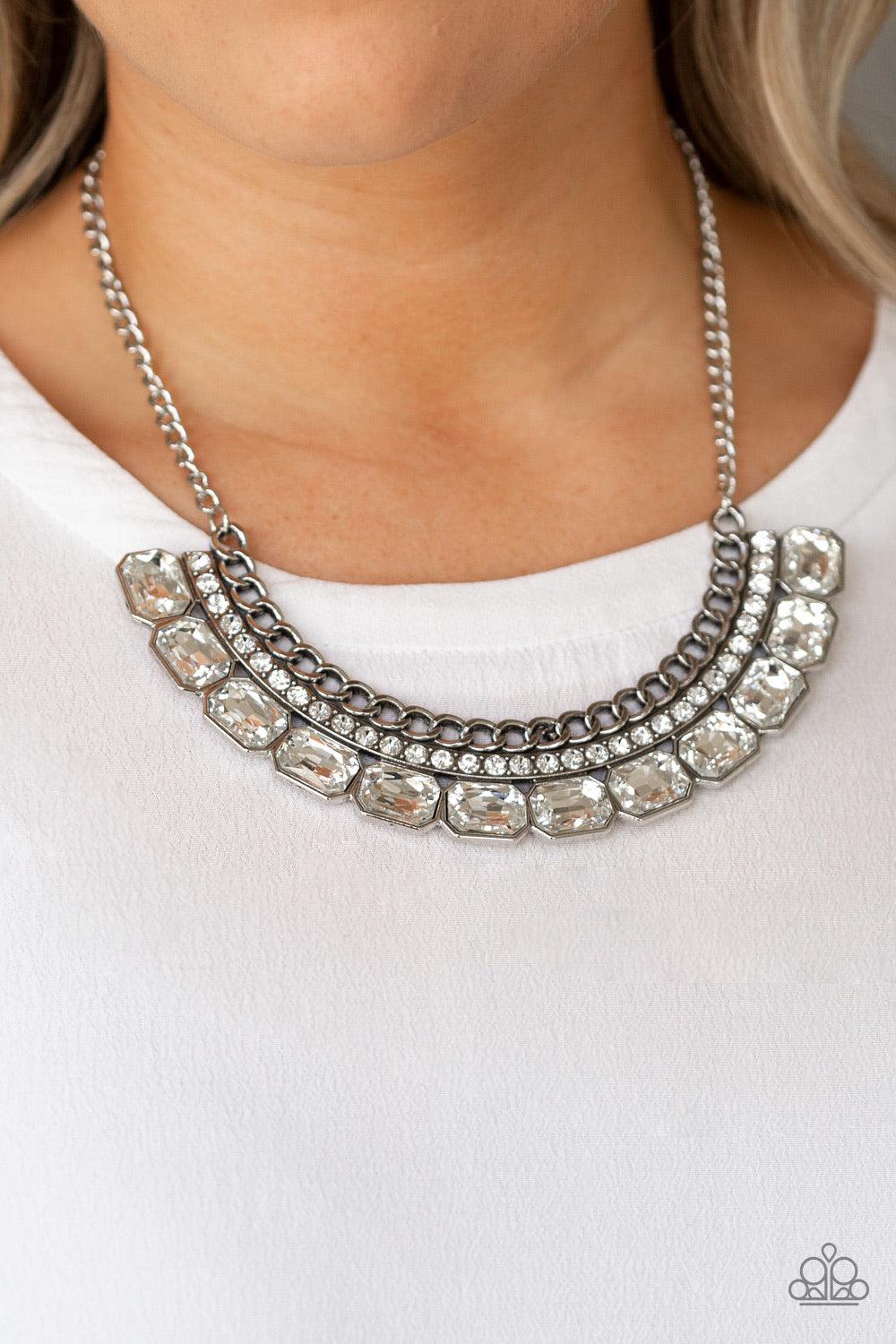 Paparazzi Accessories Killer Knockout - White Stationary rows of shimmery silver chain, glittery white rhinestones, and glassy white emerald-cut gems coalesce into a bold pendant below the collar. Features an adjustable clasp closure. Jewelry